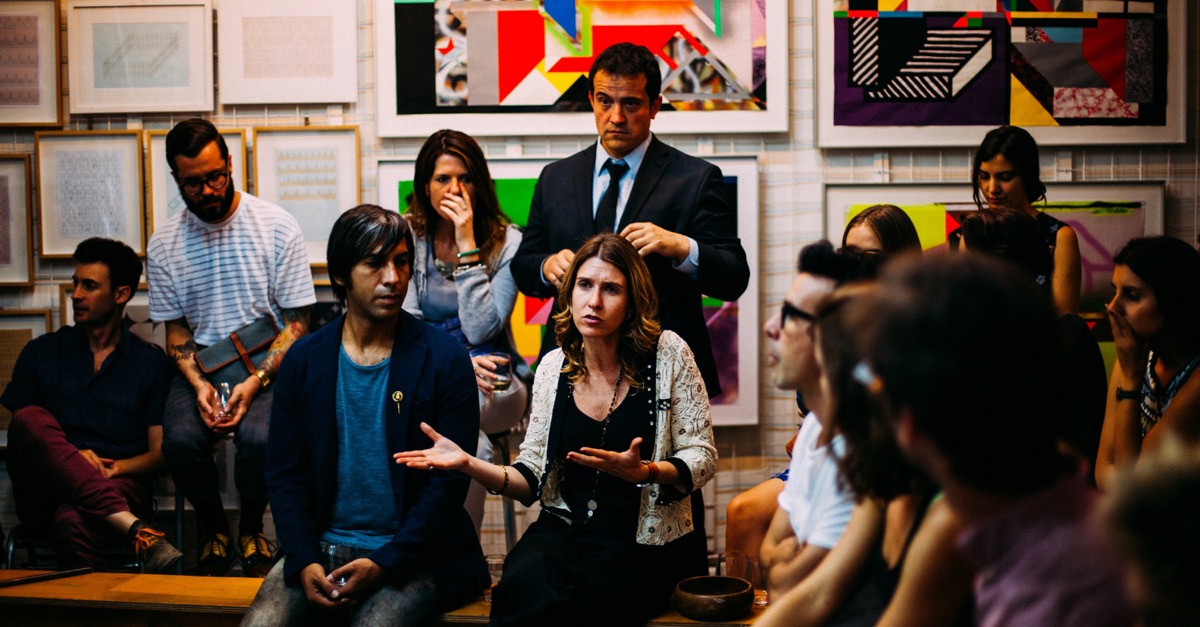 A group in conversation as one person speaks and others listen