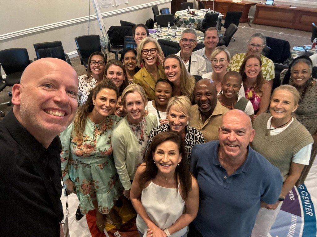 Robert Stephenson with a large group of leadership programme participants, all smiling together
